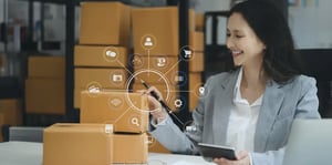 Why Composable OMS is the Future of eCommerce features a business person surrounded by boxes and different backend components of the order management process