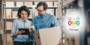 Two associates in a warehouse work on inventory planning while holding a tablet and a box.